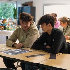 Two male students sitting at a table working on a task