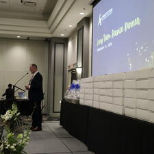 Superintendent Nosek standing on stage greeting the audience