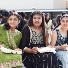Elementary students sitting and eating a lunch provided to them by the ATS PAC